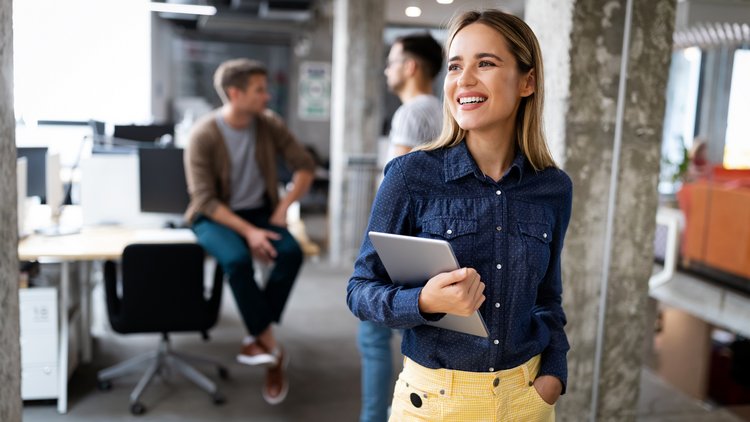 Woman in office holding tablet